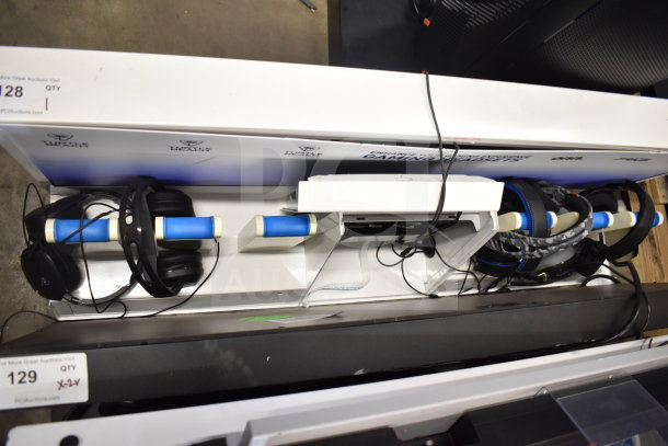Store display featuring multiple headphones on blue padded stands. Includes visible wiring. Labels show "Turtle Beach."