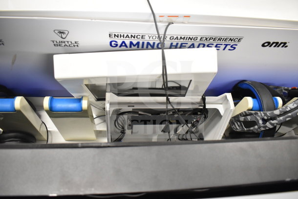 Store display featuring Turtle Beach and Onn gaming headsets, showing wiring and headset stands; good condition.