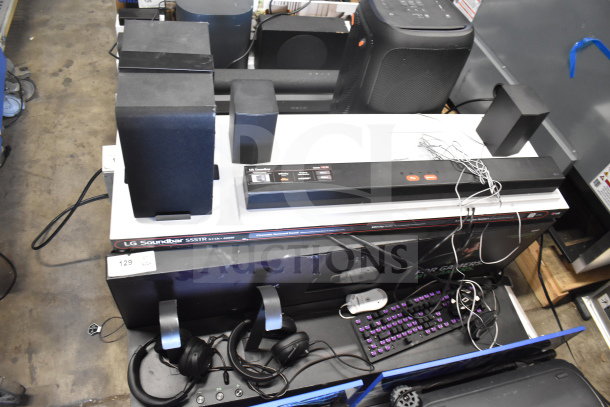LG Soundbar S55TR with speakers, headphones, and display. Includes visible cables. Condition appears used. Auction item 129.