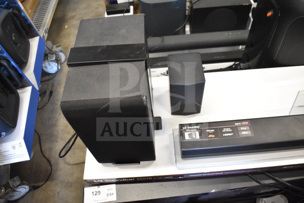 LG soundbar display with speakers. Model S65TR, 5.1 channel, 420W. Includes headphones. Store display condition.