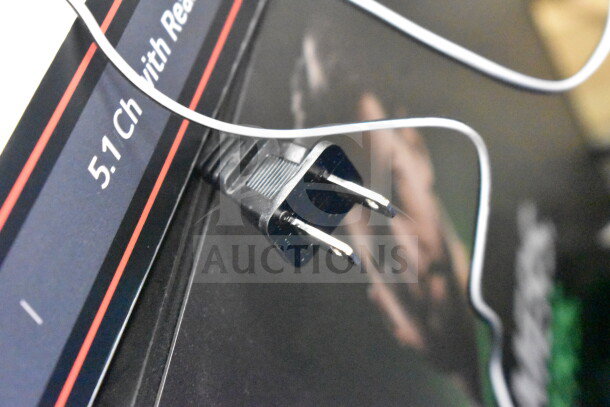 Plug and wire on sound system display with partial view of "5.1 Ch" label, indicating channel capacity.