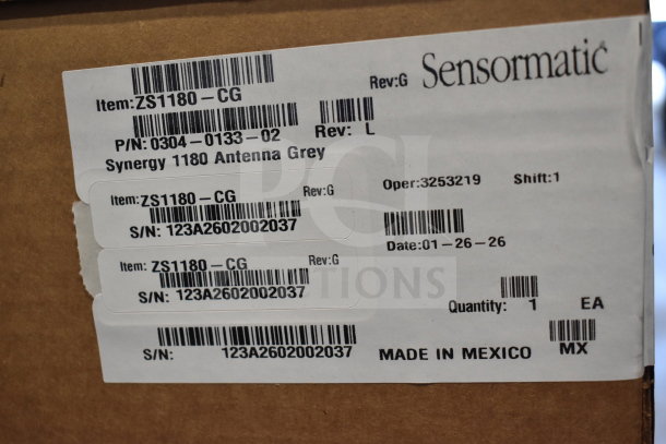 Box with Sensormatic ZS1180-CG Synergy 1180 Antenna Grey labels, indicating model and serial numbers. Made in Mexico.