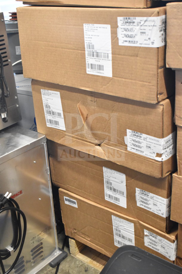 Boxes of Sensormatic ZS1180-CG Synergy 1180 Antennas in grey, labeled for shipping. Twelve units in total.