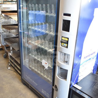 Crane 5800-4HC vending machine, accepts bills, 115V, 1 phase, for bottled drinks. Visible 25¢ price tag, Member's Mark branding.