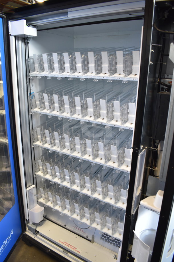 Crane 5800-4HC commercial vending machine with bill acceptor, open view. Features multiple shelves for bottled drinks.