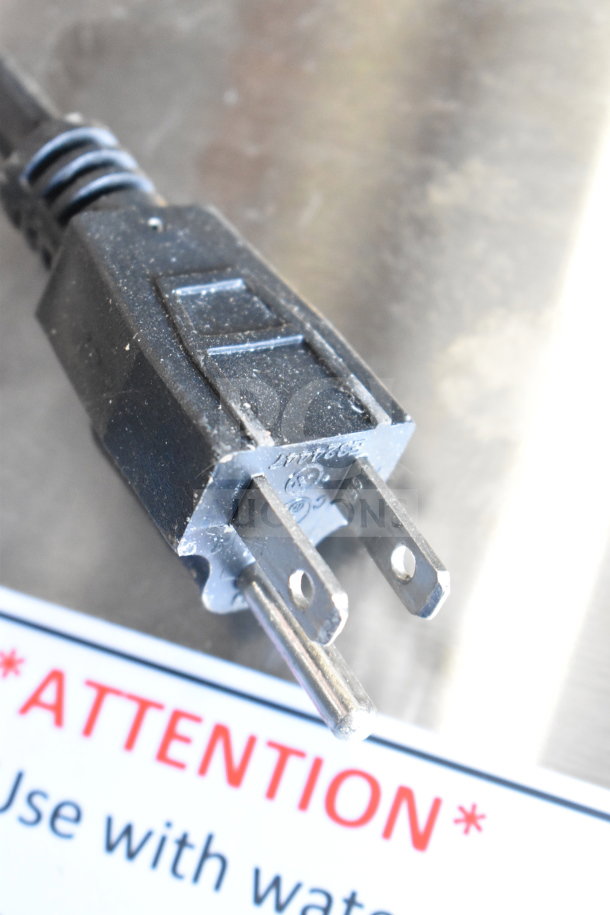 Close-up of a power plug on a Fryclone 259OFM110 fryer oil filter machine. Partial warning label visible.