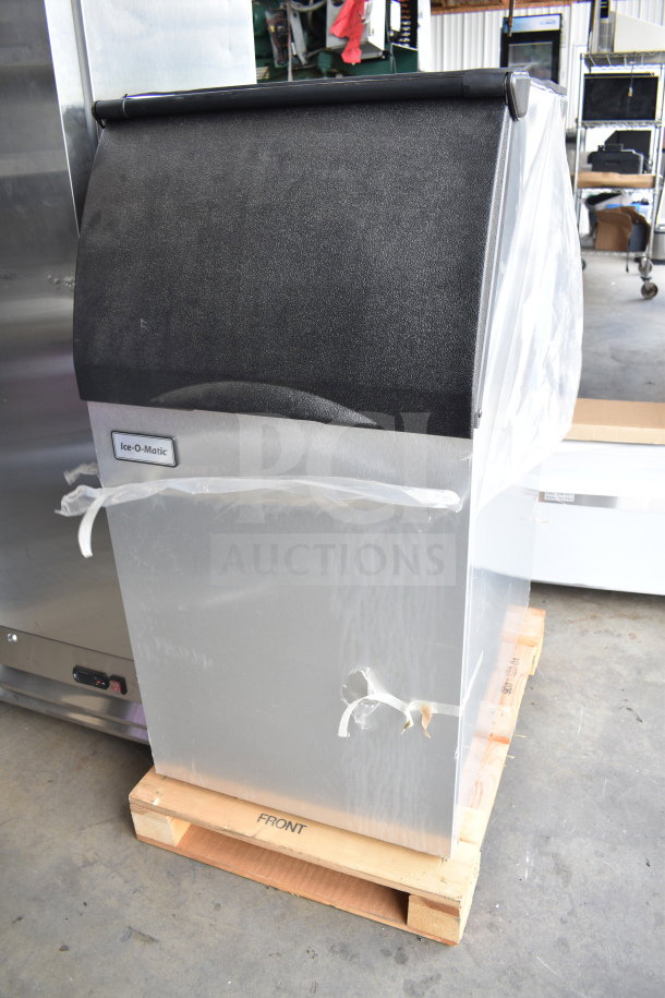 Brand new Ice-O-Matic B42 ice storage bin with minor scratches and dents, 351 lb. capacity, in plastic wrap, on a pallet.