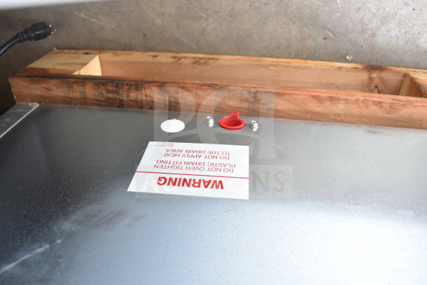 Brand new Ice-O-Matic B42 Ice Storage Bin, 351 lb capacity, with minor dents. Warning label visible on top surface.
