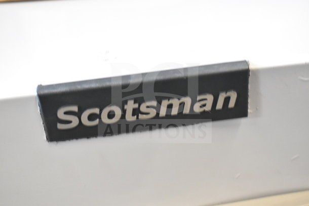 Scotsman MC0330SAX-1A ice machine badge, showing brand logo on the unit.