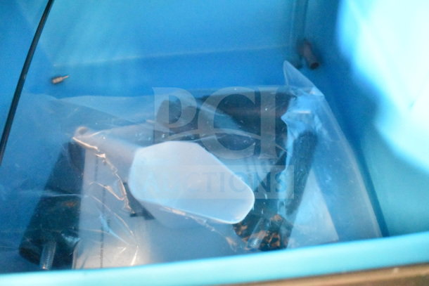 Manitowoc UDP0065A-161 ice machine, 31 lb. bin, new condition, 62 lb. capacity, visible scoop and accessories inside.