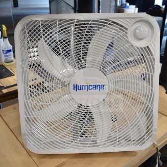 Hurricane HGC736501 box fan, white, 115 volts, 1 phase, shown on wooden surface. Brand logo visible on center.
