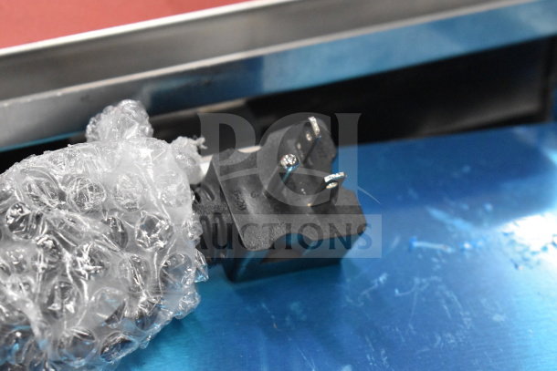 Close-up of the plug for the 2025 Avantco 177F202 fryer, wrapped in bubble wrap, showing a 3-prong plug design.