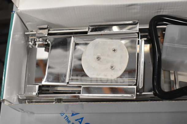 Stainless steel mandoline with built-in blades and julienne set in original packaging, minor scratches visible.