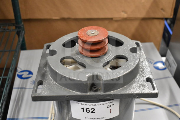 Brand new YC167-4-X motor, 240 volts, showing minor scratches. Auction tag reads "162 QTY 1 PCIAuctions.com."