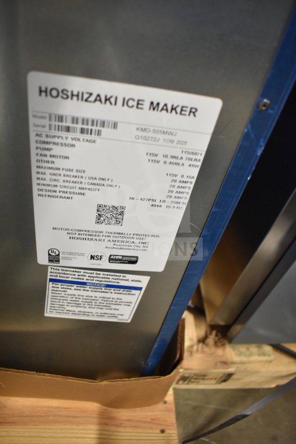 Brand new 2025 Hoshizaki KMD-505MWJ crescent cube ice machine, 592 lb capacity, 115V, 1 phase. Label with specs visible.
