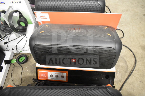 JBL speaker store display featuring multiple units. Includes control panel with volume and play controls.