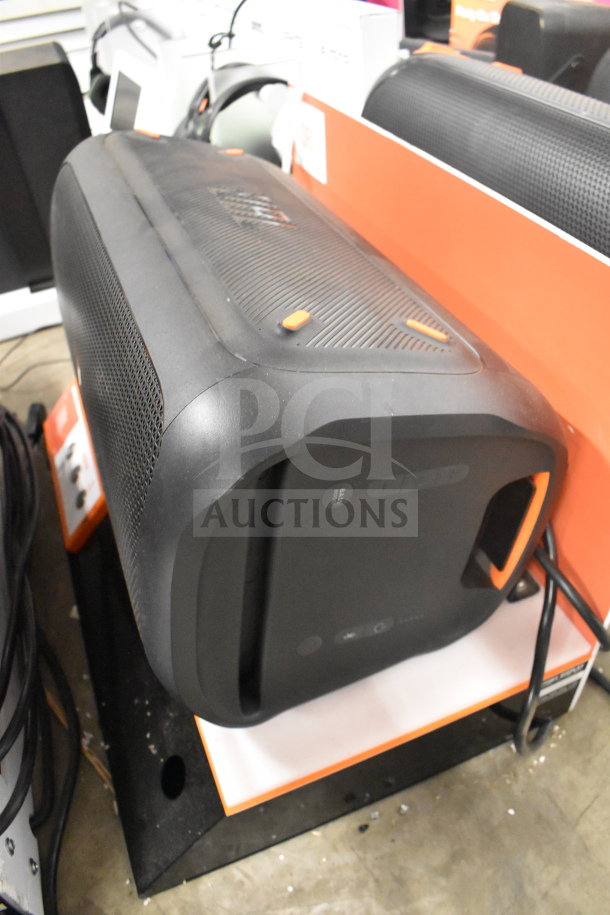 Store display featuring JBL speaker in excellent condition, with sleek black design and control panel. Perfect for retail.