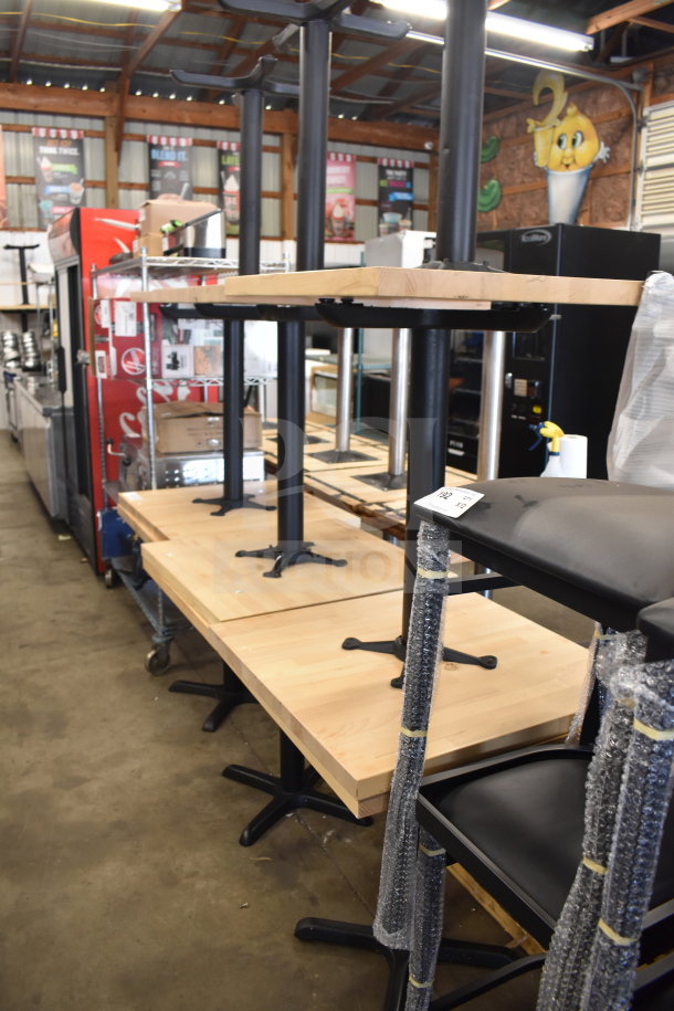 12 wood pattern dining height tables with black metal bases, in new condition. Auction includes 12 tables.