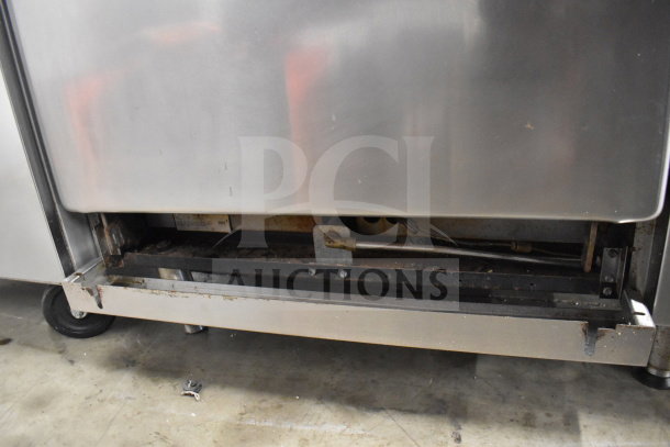 Imperial Commercial 6 Burner Range, gas-powered, includes oven, over shelf, back splash. Visible wear on the base.