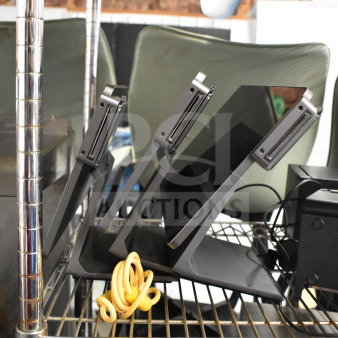 Three POS monitors including Pax L1400, in good condition, on a metal shelf with power cords.