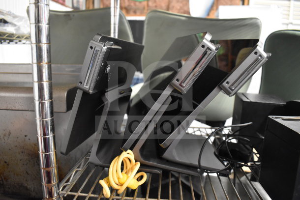 Three Pax L1400 POS monitors on a metal shelf. Sleek design, card readers attached, good condition. Bundled wires visible.