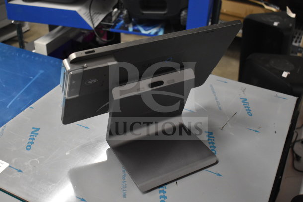 Three POS monitors including Pax L1400, shown in excellent condition with a sleek design and stable stands.