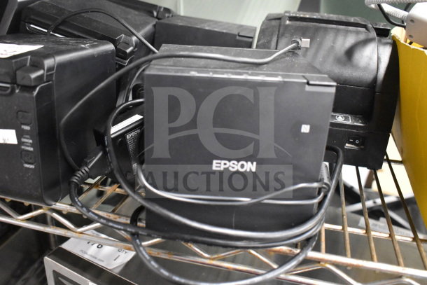 Seven receipt printers including SNBC BTP-S80 and Epson M374C, used condition, cords attached, multiple units shown.