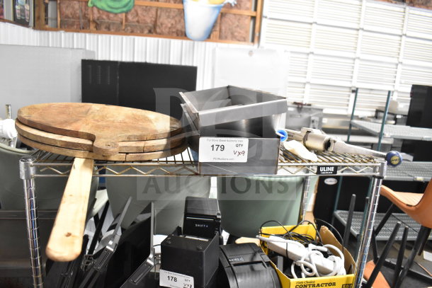 Nine varied items including metal bins, wooden paddles, and a gas regulator on a wire shelf. Tag indicates quantity nine.