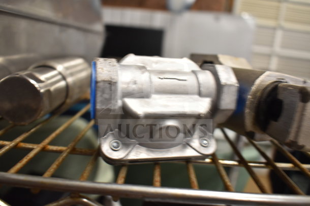 Metal gas regulator on a shelf, part of a lot including bins and wooden paddles. Used condition, industrial setting.
