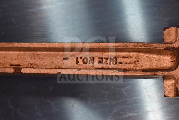 Metal item marked "SIZE NO.1" with visible rust; part of a lot including bins, wooden paddles, leg, gas regulator.