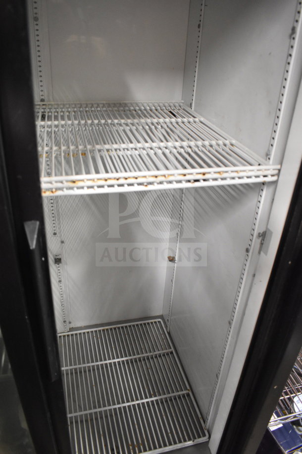 True GDM-33 commercial 2-door cooler merchandiser with shelves, white interior, 115 volts. Shows use, suitable for retail display.