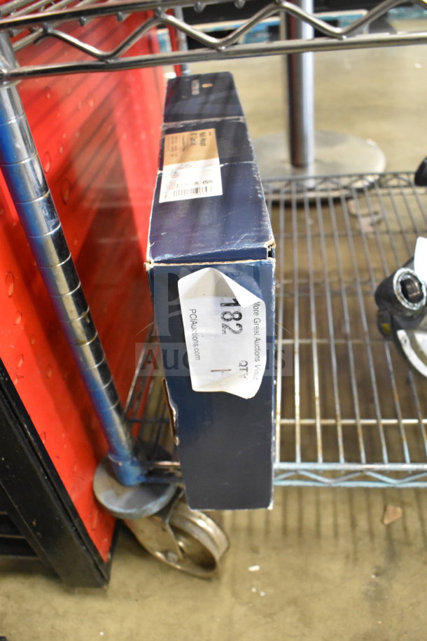 Boxed Waterloo 750FW88G wall-mount faucet, brand new with minor dents, 8" gooseneck spout, 8" centers, auction tag visible.