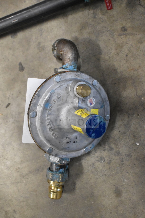 Maxitrol gas regulator with brass fittings, visible wear. Markings: "Maxitrol," "2142 11," "NAT 8.0." Includes American flag sticker.