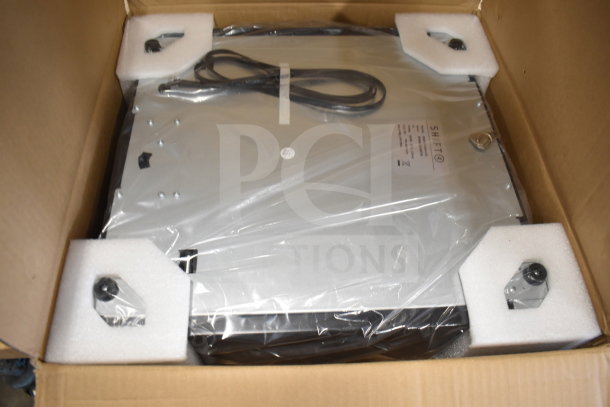 "Brand new 2024 Shift cash drawer in original packaging, showing visible minor scratches and dents, includes power cord."
