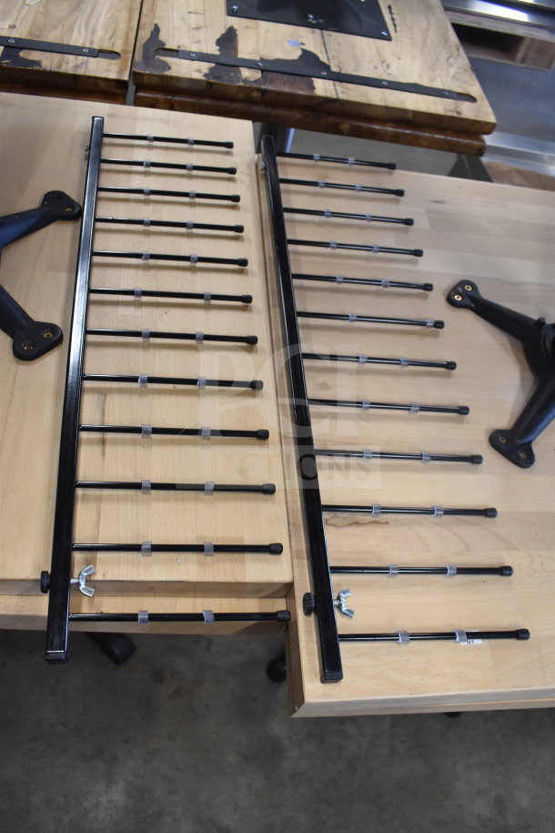Two black metal ladder-like pieces with adjustable crossbars, perfect condition, part of the auction lot including a Yeler Plastic Film Sealer.