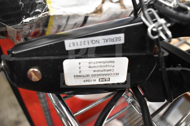 Serial number label on Yeler Plastic Film Sealer, black metal frame. Brand: Uline H-1069. Scratch and dent condition.