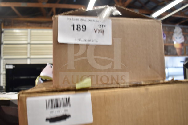 Cardboard boxes labeled with auction details, featuring items like Vigor 473SSAUCP7 7.6 Qt. Stainless Steel Sauce Pan.