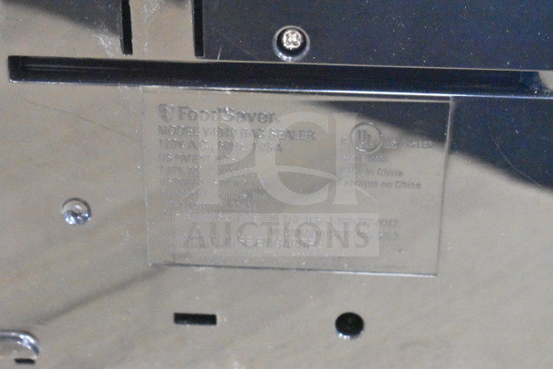 Brand new FoodSaver V4840 bag sealer with visible label, 120V, scratch and dent condition. Model details shown.