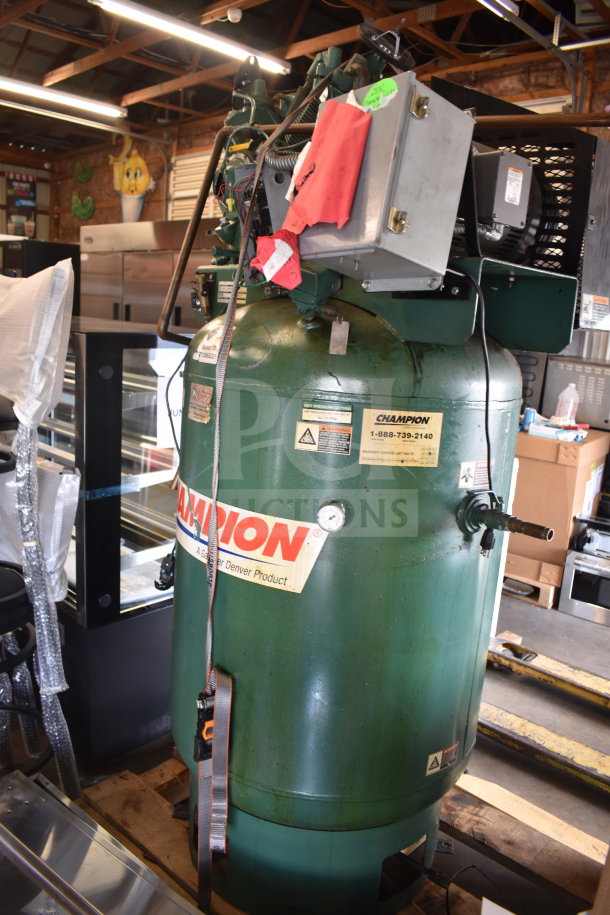 Champion CAPRSA23 air compressor, 460V, 3-phase, green, visible labels, industrial condition, mounted on a pallet.