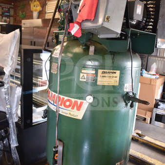 Champion CAPRSA23 air compressor, 460V, 3-phase, green, visible labels, industrial condition, mounted on a pallet.