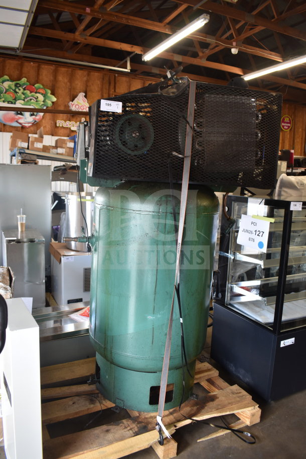 Champion CAPRSA23 air compressor, green, 460 volts, 3 phase, secured on a wooden pallet, shows moderate wear.
