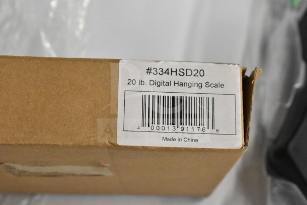 Brown box with a label reading "20 lb. Digital Hanging Scale #334HSD20." Barcode and "Made in China" text visible.