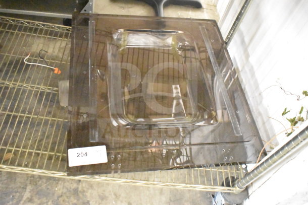 Brand new vacuum sealer lid, scratch and dent, transparent, rectangular shape, slight markings. Label reads "204."