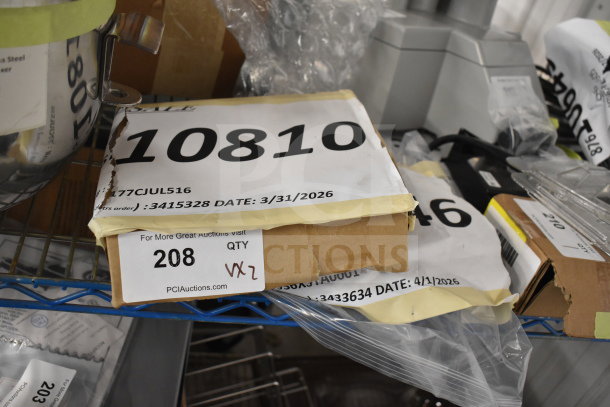 Brand new Vollrath XSTA0001 stove element and AvaMix 5/16" julienne disc; auction items with visible tags.