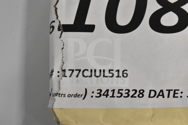 "Paper with torn edge showing part numbers 177CJUL516 and 3415328, related to auction items."