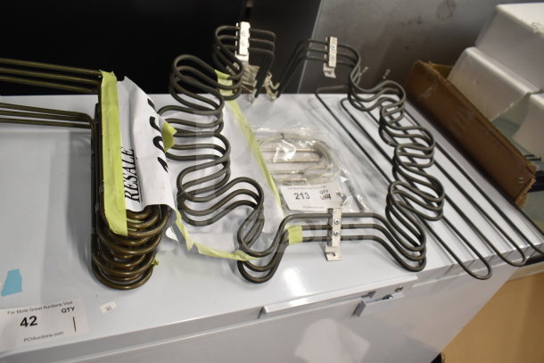 4 brand new heating elements including Hatco X02.08.675.00, Garland 4518356, and Pitco 50006605, tagged for auction.