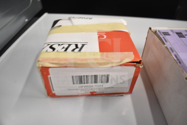 Box labeled HPXRDE7004, containing Vollrath XRDE7004 Red Temp Cntr, part of auction with six brand new items.