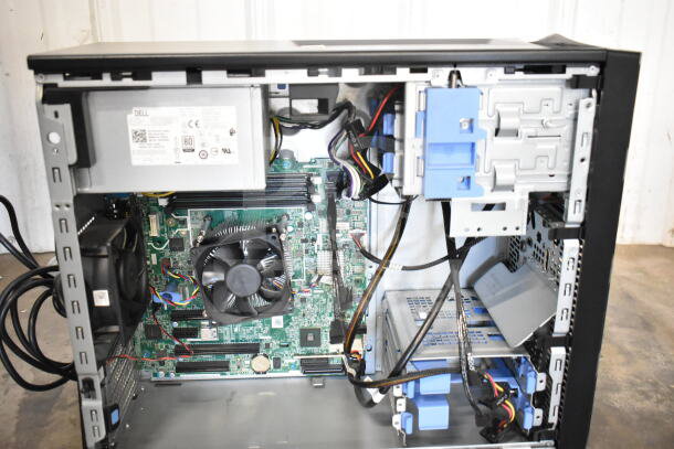 Dell PowerEdge T130 computer tower, internal view showing motherboard, cooling fan, power supply, cables, in good condition.
