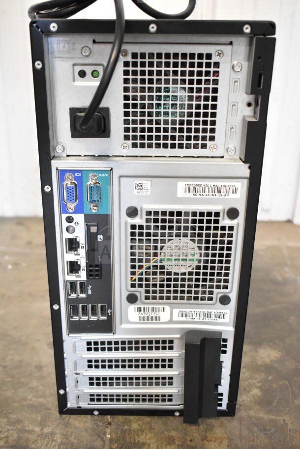 Dell PowerEdge T130 computer tower, rear view. Features various ports, cooling vents, and visible labels with MAC addresses.