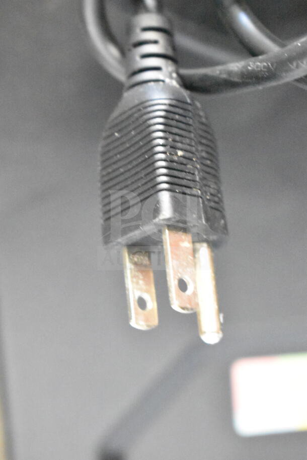 Close-up of a power plug connected to a Dell PowerEdge T130 computer tower.